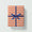 Gift box with orange and white stripes and a blue ribbon on a light gray background